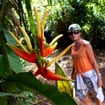 Woman with bird of paradise flower in jungle