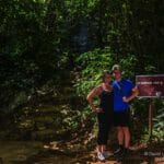 Couple with sign for St Herman&#039;s cave in Belize