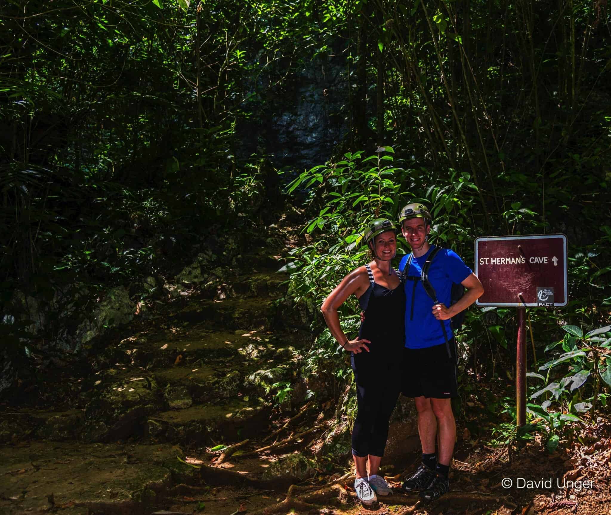 Couple with sign for St Herman's cave in Belize