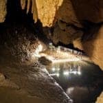 Headlamps reflected in pool in St Herman&#039;s cave in Belize